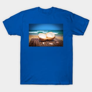 Coconut on the table against beautiful beach T-Shirt